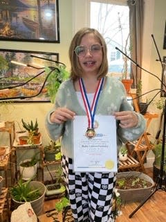 Ruby Labuschewsky poses for a photograph with her World Record acknowledgment.