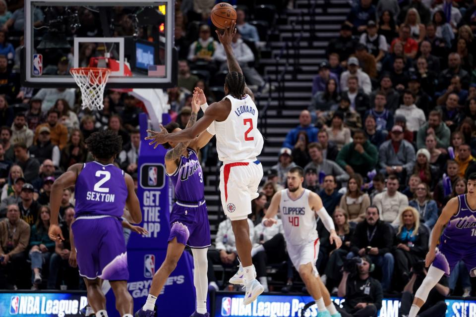 LA Clippers forward <a class="link " href="https://sports.yahoo.com/nba/players/4896" data-i13n="sec:content-canvas;subsec:anchor_text;elm:context_link" data-ylk="slk:Kawhi Leonard;sec:content-canvas;subsec:anchor_text;elm:context_link;itc:0">Kawhi Leonard</a> (2) shoots over Utah Jazz guard <a class="link " href="https://sports.yahoo.com/nba/players/10100" data-i13n="sec:content-canvas;subsec:anchor_text;elm:context_link" data-ylk="slk:Keyonte George;sec:content-canvas;subsec:anchor_text;elm:context_link;itc:0">Keyonte George</a> (3) at the Delta Center in Salt Lake City on Friday, Dec. 8, 2023. | Spenser Heaps, Deseret News