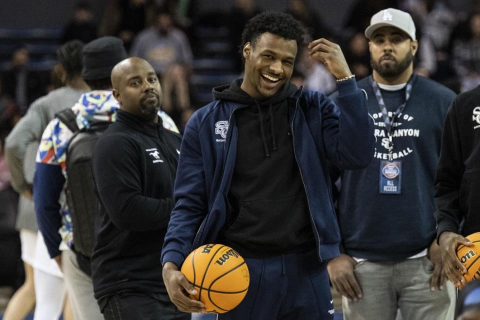 Sierra Canyon's Bronny James (0) laughs before a Mission League game at Pauley Pavillion.