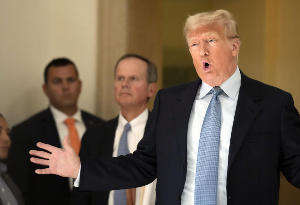 Former President Donald Trump comments to the media during a break of his civil business fraud trial at New York Supreme Court, Wednesday, Oct. 18, 2023, in New York. (AP Photo/Seth Wenig)