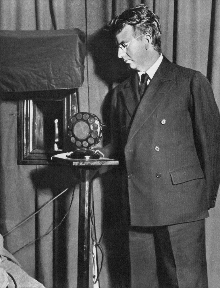 John Logie Baird, one of the inventors of mechanical television, watching the first televised play, The Man With a Flower in his Mouth.