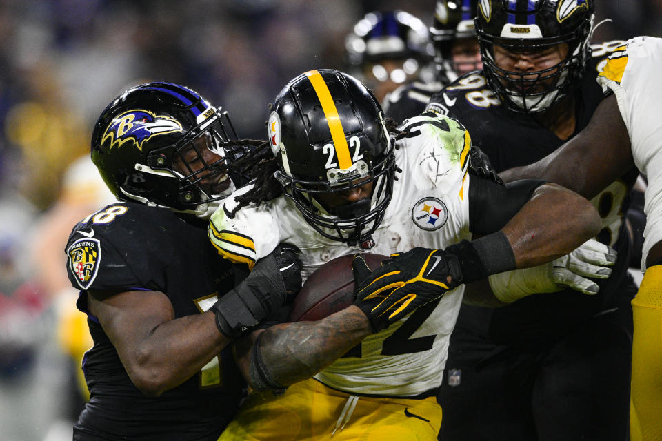 Pittsburgh Steelers running back Najee Harris (22) is tackled by Baltimore Ravens linebacker Roquan Smith (18) and defensive tackle Travis Jones (98) in the second half of an NFL football game in Baltimore, Fla., Sunday, Jan. 1, 2023. (AP Photo/Nick Wass)
