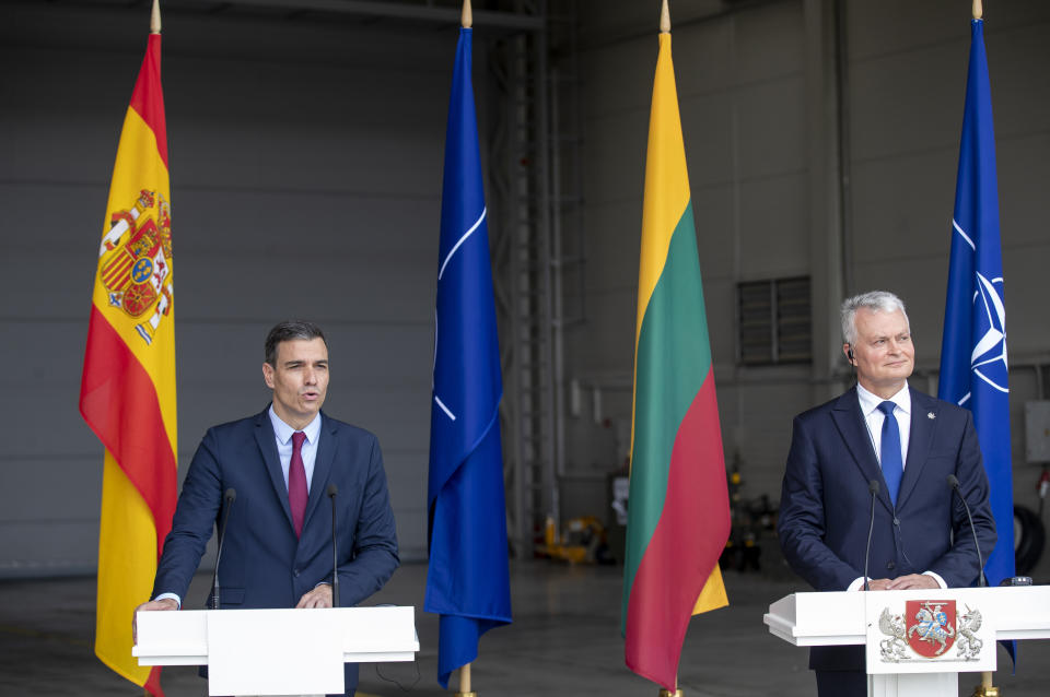 Lithuania's President Gitanas Nauseda and Spain's Prime Minister Pedro Sanchez, left, answers questions during a meeting with the press at the Siauliai military air force base some 220 kms (136,7 miles) east of the capital Vilnius, Lithuania, Thursday, July 8, 2021. (AP Photo/Mindaugas Kulbis)
