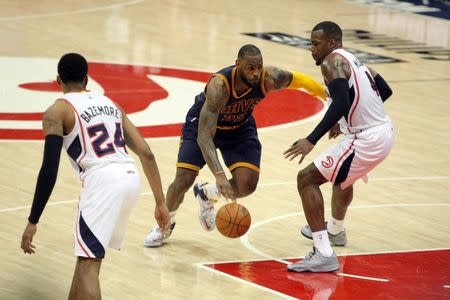 Cleveland Cavaliers forward LeBron James (23) drives against Atlanta Hawks forward Paul Millsap (4) during the fourth quarter of game one of the Eastern Conference Finals of the NBA Playoffs at Philips Arena. Cleveland won 97-89. Mandatory Credit: Brett Davis-USA TODAY Sports