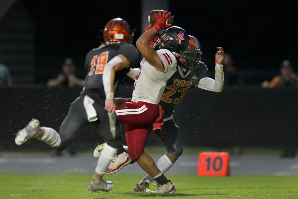 Bishop Kenny's Jackson Burnett (8) pulls in a long pass against Tocoi Creek.