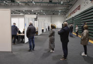 People vote at a local sports complex in Kopavogur, Iceland, Saturday, Sept. 25, 2021. Icelanders are voting in a general election dominated by climate change, with an unprecedented number of political parties likely to win parliamentary seats. (AP Photo/Arni Torfason)