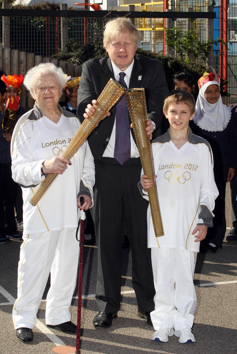 London 2012 Olympic Torchbearer's Dinah Gould aged 99 (left) and Dominic John MacGowan aged 11 (right) with London Mayor Boris Johnson during a photocall at Redlands Primary School, London.