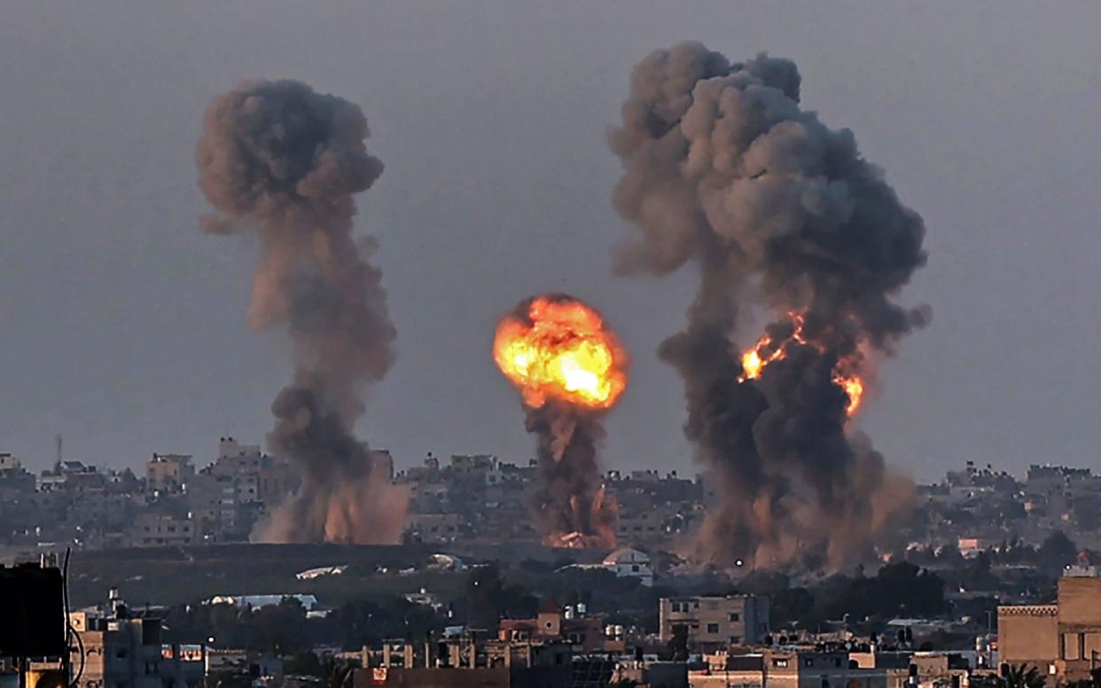 Smoke and a ball of fire rise above buildings in Khan Yunis in the southern Gaza Strip, during an Israeli air strike, on May 12, 2021.  - AFP