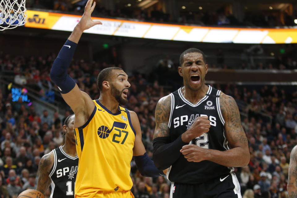 Utah Jazz center Rudy Gobert (27) reacts after fouling San Antonio Spurs forward LaMarcus Aldridge, right, during the first half of an NBA basketball game Friday, Feb. 21, 2020, in Salt Lake City. (AP Photo/Rick Bowmer)