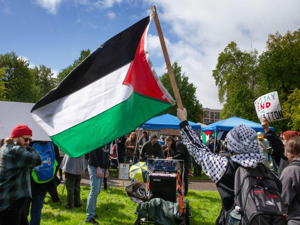 Supporters march around a protest camp at the University of Oregon demanding justice in the Palestinian territories. On Monday morning April 29, 2024 over 30 tents and other structures were in place between Lillis Hall and the Knight Library on the UO campus in Eugene.