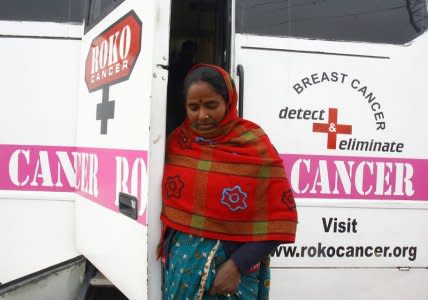 FILE PHOTO: A woman comes out from a mobile cancer detection unit after her mammography examination during a free medical check-up camp in a slum area in the northern Indian city of Chandigarh February 6, 2011. REUTERS/Ajay Verma