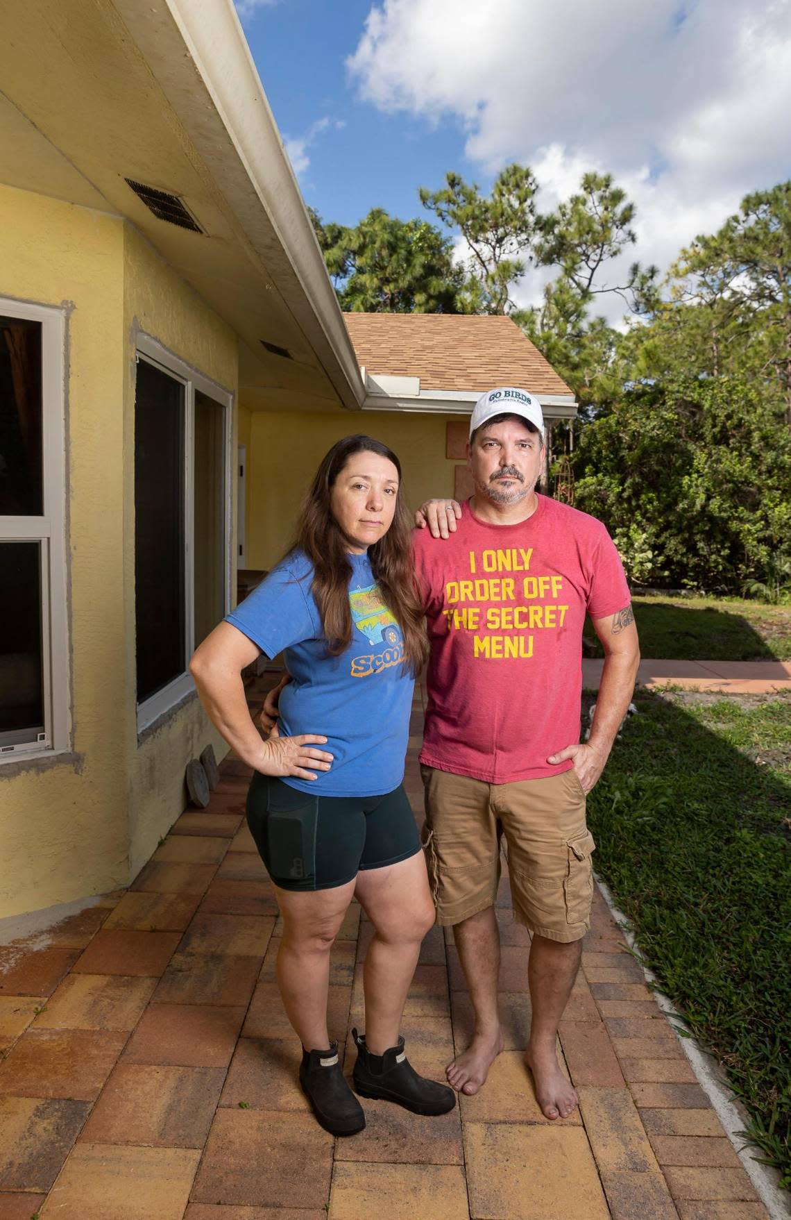 Kelly Coulter, 44, and her husband, Ray Coulter, 53, are photographed at their home on Wednesday, Jan. 31, 2023, in West Palm Beach, Fla. The Coulters used Ygrene funding to finance a brand new roof and impact windows before Ygrene yanked the financing for everyone in Florida.