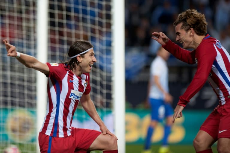 Atletico Madrid's Filipe Luis (L) celebrates with Antoine Griezmann after scoring against Malaga at La Rosaleda stadium in Malaga on April 1, 2017