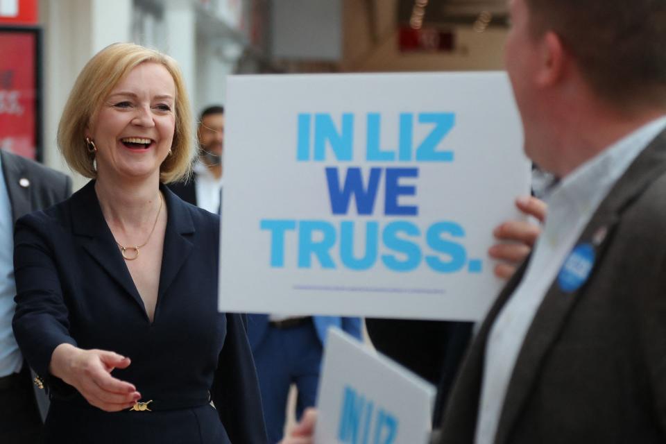 Liz Truss reacts as she is greeted by supporters upon her arrival to attend a Conservative Party campaign event in Birmingham, on Aug. 23, 2022.