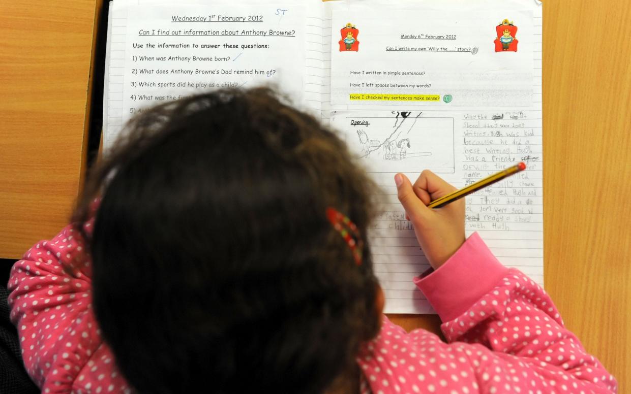 Primary school child at work in a classroom - Dominic Lipinski/PA