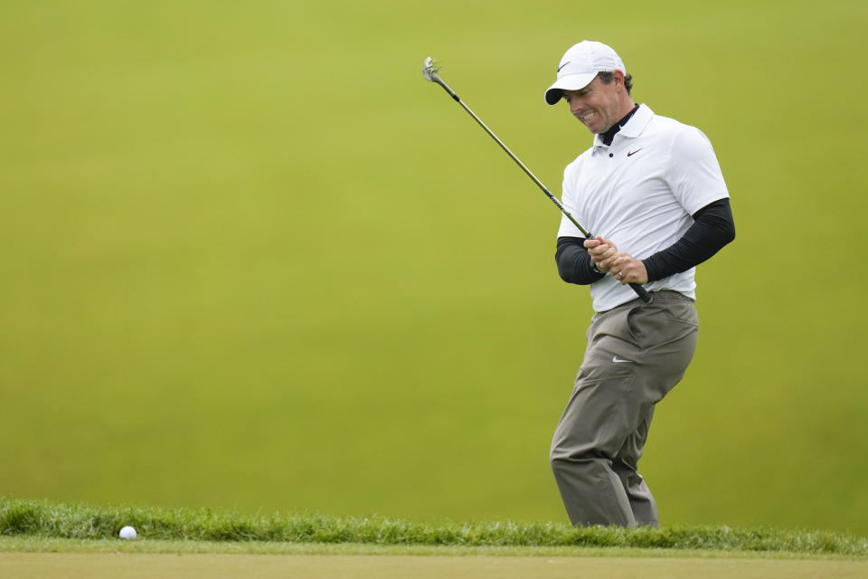 Rory McIlroy, of Northern Ireland, chips to the green on the 18th hole during the third round of the PGA Championship golf tournament at Oak Hill Country Club on Saturday, May 20, 2023, in Pittsford, N.Y. (AP Photo/Seth Wenig)