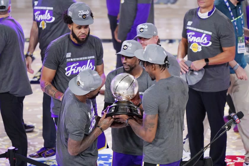 The Los Angeles Lakers celebrate after beating the Denver Nuggets in an NBA conference final playoff basketball game Saturday, Sept. 26, 2020, in Lake Buena Vista, Fla. The Lakers won 117-107 to win the series 4-1. (AP Photo/Mark J. Terrill)