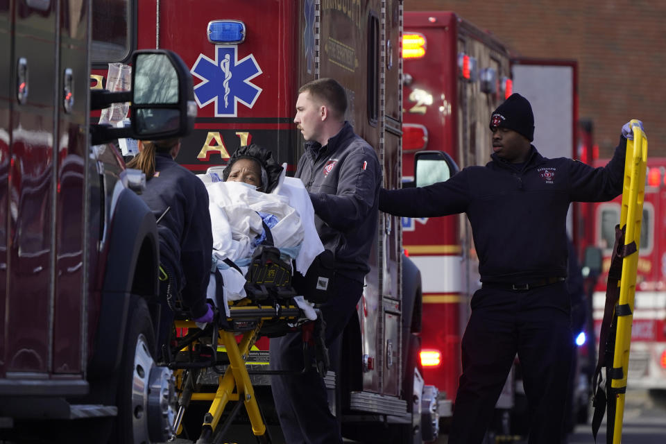 A patient, center left, is placed into an ambulance while being evacuated from Signature Healthcare Brockton Hospital, Tuesday, Feb. 7, 2023, in Brockton, Mass. A fire at the hospital's electrical transformer forced an undetermined number of evacuations Tuesday morning and power was shut off to the building for safety reasons, officials said. (AP Photo/Steven Senne)