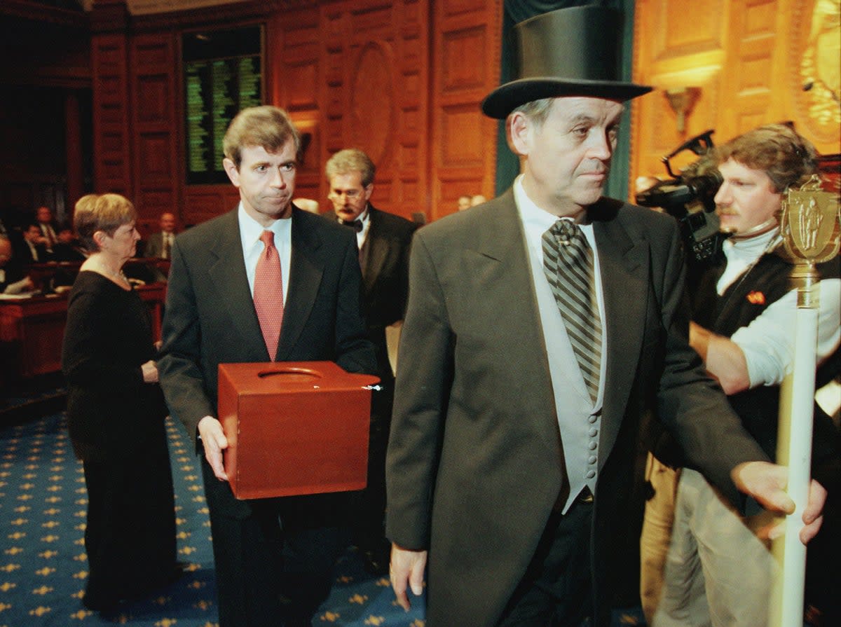 Massachusetts Secretary of the Commonwealth William Galvin, centre, carries a ballot box containing the 12 Massachusetts electoral votes for Vice President Al Gore as he is led by Sergeant-at Arms Michael Rea, right, during the Electoral College voting at the Statehouse on 18 December 2000 in Boston (Getty Images)