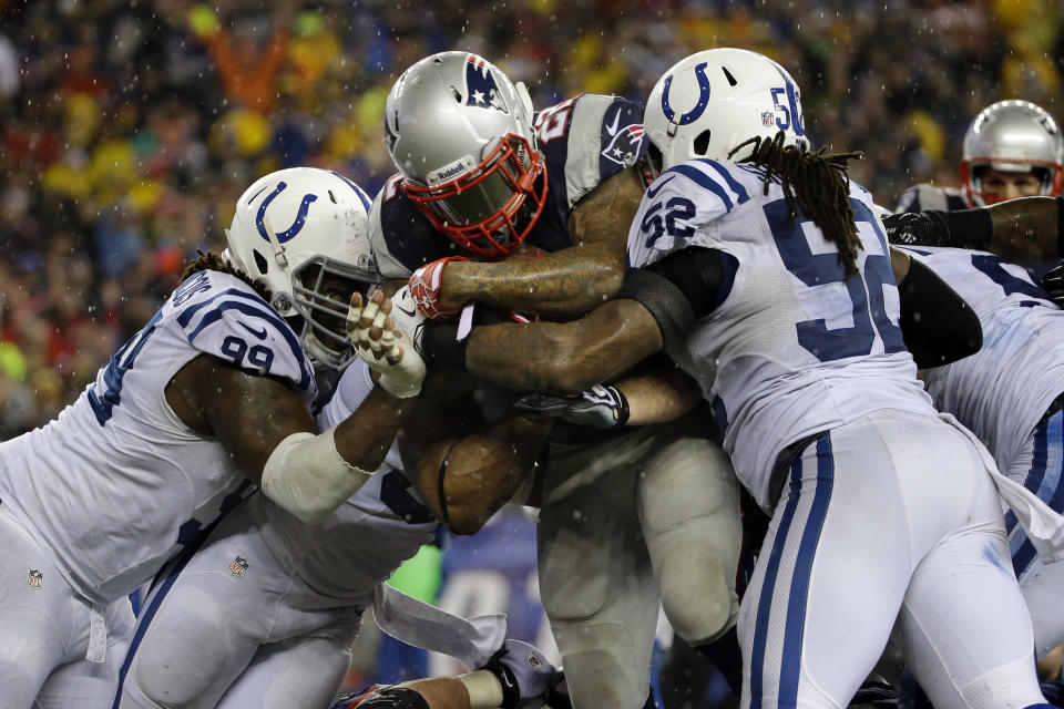 New England Patriots running back Stevan Ridley (22) plows his way between Indianapolis Colts defensive end Ricky Jean Francois (99) and linebacker Kelvin Sheppard (52) for a two point conversion during the second half of an AFC divisional NFL playoff football game n Foxborough, Mass., Saturday, Jan. 11, 2014. (AP Photo/Matt Slocum)