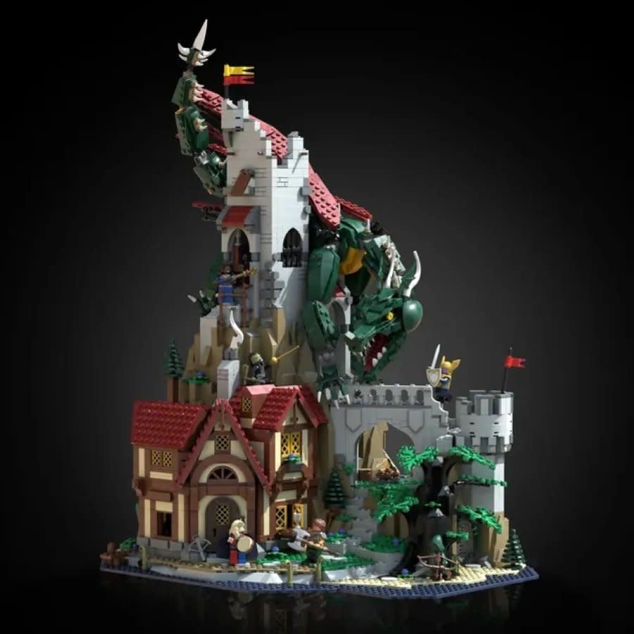 A castle and buildings with a green dragon made of LEGO