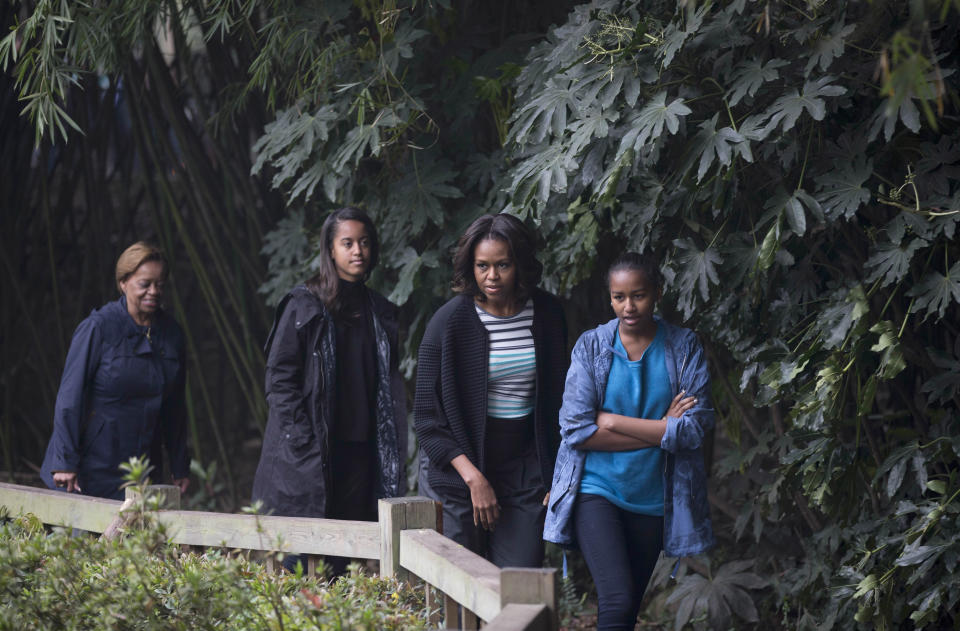First lady Michelle Obama walks with her daughters Sasha and Malia and her mother Marian Robinson on their way to see pandas at the Giant Panda Research Base in Chengdu in southwest China's Sichuan province Wednesday, March 26, 2014.