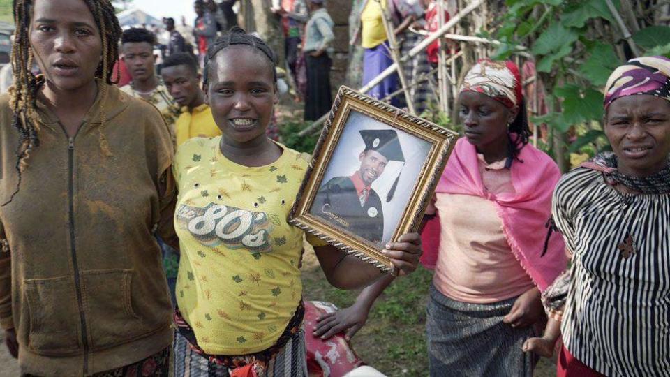 People holding a photo of one of those who died in a landslide in Gofa, Ethiopia - July 24, 2024