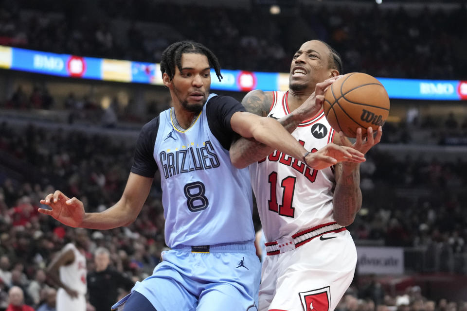 Chicago Bulls' DeMar DeRozan (11) drives to the basket and is fouled by Memphis Grizzlies' Ziaire Williams during the first half of an NBA basketball game Saturday, Jan. 20, 2024, in Chicago. (AP Photo/Charles Rex Arbogast)