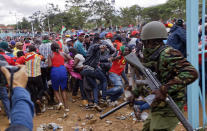 <p>Supporters of President Uhuru Kenyatta engage in rock-throwing clashes with police at his inauguration ceremony after trying to storm through gates to get in and being tear-gassed, at Kasarani stadium in Nairobi, Kenya Tuesday, Nov. 28, 2017. (Photo: Ben Curtis/AP) </p>