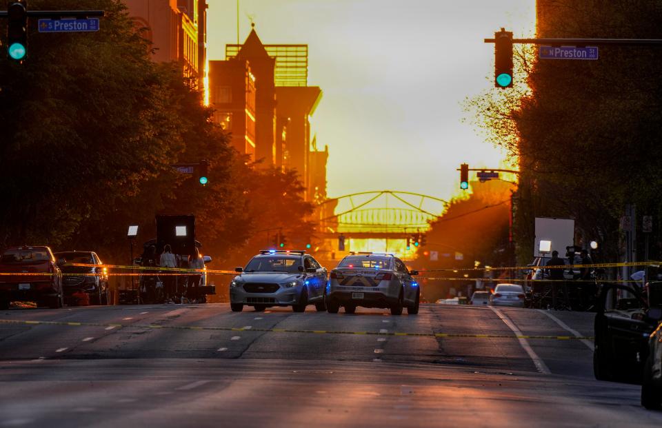 The sun sets as Main Street at Preston Street remains closed as Louisville Metro Police Department is still on the scene several hours after a shooting at the Old National Bank downtown that left five people dead and at eight others injured Monday, April 10, 2023. The suspect gunman is also dead according to police.