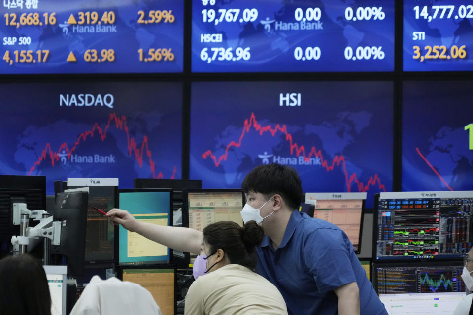 Currency traders watch monitors at the foreign exchange dealing room of the KEB Hana Bank headquarters in Seoul, South Korea, Thursday, Aug. 4, 2022. Asian shares mostly rose Thursday as investors welcomed encouraging economic data and quarterly earnings reports from big companies. (AP Photo/Ahn Young-joon)