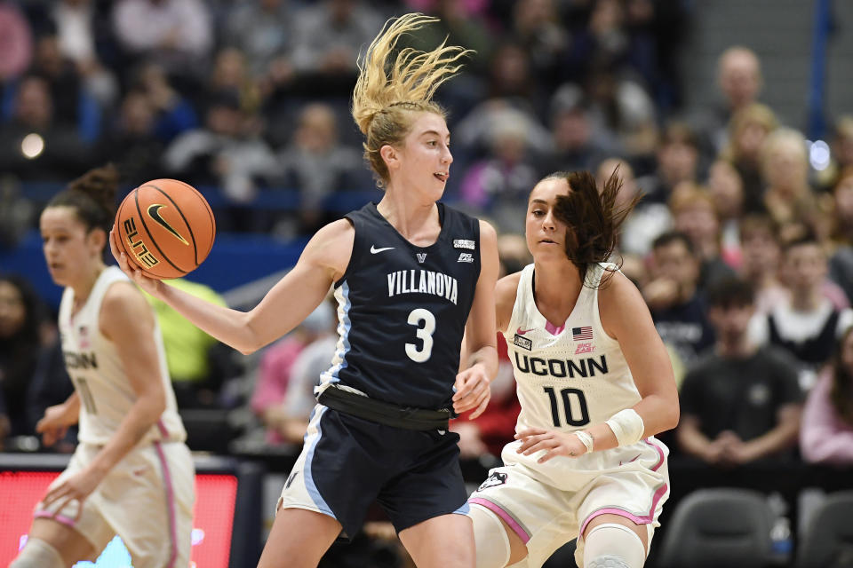 Villanova's Lucy Olsen (3) passes the ball as UConn's Nika Muhl (10) defends in the second half of an NCAA college basketball game, Sunday, Jan. 29, 2023, in Hartford, Conn. (AP Photo/Jessica Hill)