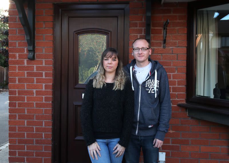 Claire Tomlinson and her partner Ricky Collier pose for a portrait in Sandbach