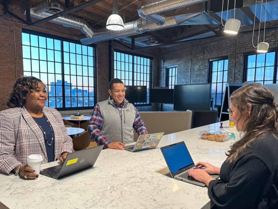 Three people working at a table