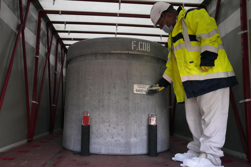 A technician works inside a truck with radioactive waste in the Aube region of eastern France, in Soulaines-Dhuys, Friday, Oct. 29, 2021. Deep in a French forest of oaks, birches and pines, a steady stream of trucks carries a silent reminder of nuclear energy’s often invisible cost: canisters of radioactive waste, heading into storage for the next 300 years. (AP Photo/Francois Mori)