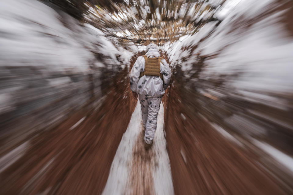 A Ukrainian serviceman walks in a trench at a frontline position in the Donetsk region, eastern Ukraine, Monday, Jan. 31, 2022. (AP Photo/Vadim Ghirda)