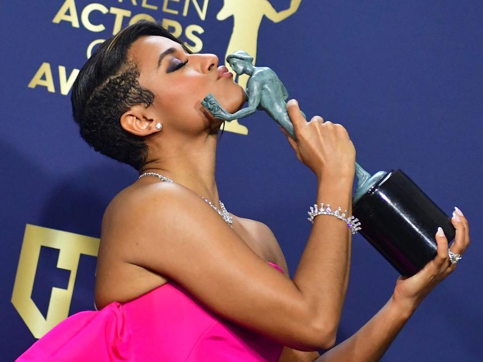 Ariana DeBose kisses her SAG award for best supporting actress at the 2022 SAG Awards