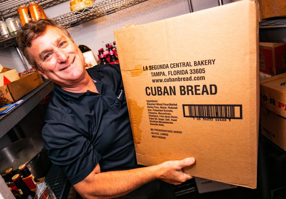 Molly Maguire's owner George Carrasco shows off a box of Cuban bread that he gets from Ybor City in Tampa.