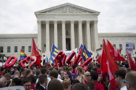 Supporters of gay marriage rally after the U.S. Supreme Court ruled on Friday that the U.S. Constitution provides same-sex couples the right to marry at the Supreme Court in Washington June 26, 2015. REUTERS/Joshua Roberts