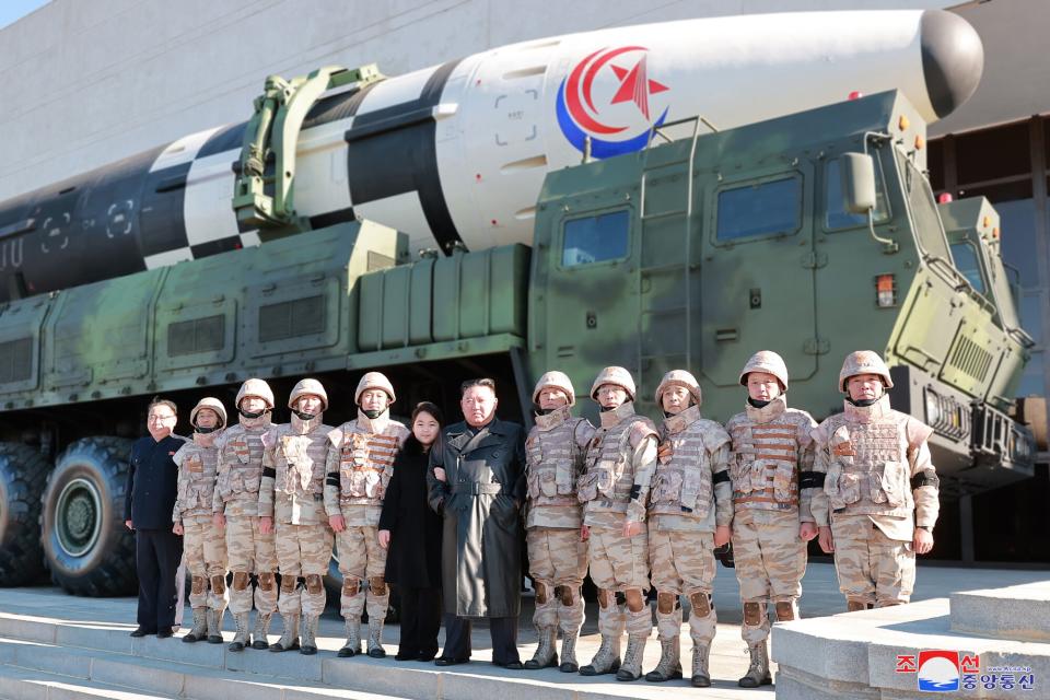 An undated photo released by the official North Korean Central News Agency (KCNA) on 27 November 2022 shows North Korean leader Kim Jong-un (C) posing with his daughter, presumed to be his second child, Ju-ae (C-L), during a photo session with the contributors to the successful test-fire of new-type ICBM Hwasongpho-17 at an undisclosed location in North Korea. Successful test launch of Hwasongpho-17, Pyongyang, North Korea - 27 Nov 2022