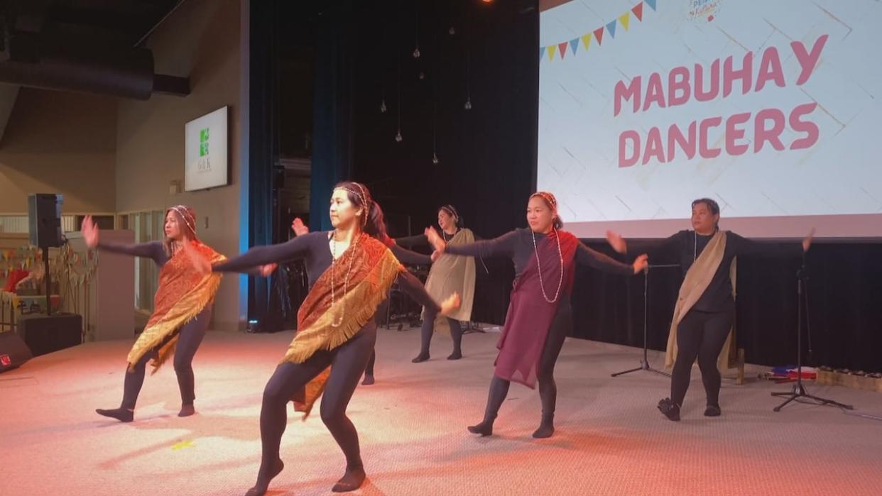 Filipino dancers entertain the crowd during PEIsta Kultura 2024 on Saturday in Summerside. (Victoria Walton/CBC - image credit)