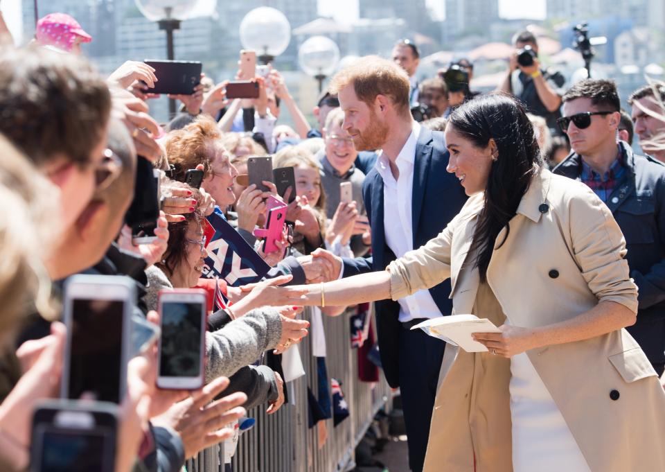 Meghan Markle and Prince Harry met a girl who looked just like a young Markle while in Sydney, Australia. Of course they broke royal protocol to take a pic.