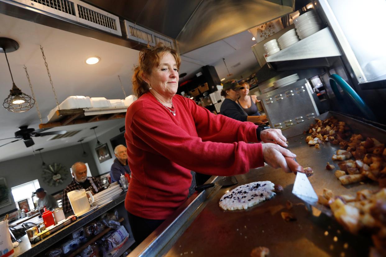 Sarah Simmons, owner, prepares a blueberry pancake and home fries at the Little Phoenix Restaurant on Acushnet Avenue in New Bedford.