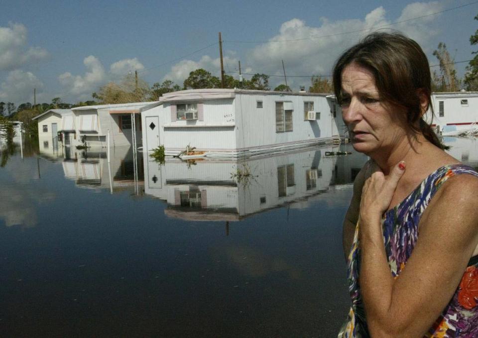 In this Sept. 28, 2004, file photo, Kathleen Cole, a resident of the Cypress Bay Mobile Home Park in Fort Pierce, was one of many residents flooded out of their trailers since Hurricane Jeanne. She and her family had been living in the recreation center of the park while waiting for waters to recede or get pumped out. The park still had partial flooding from Hurricane Frances when it got hit by Jeanne.