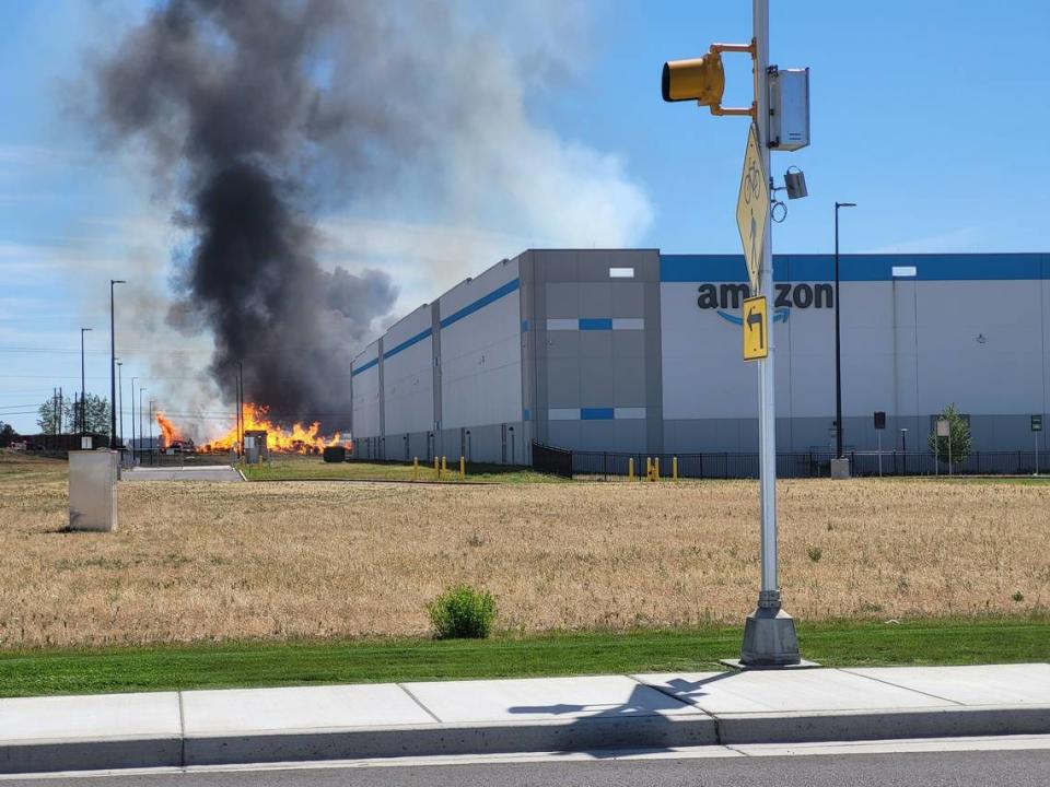 The fire at Tri-City Pallets can be seen from Road 40 in Pasco, near one of Amazon’s warehouses.