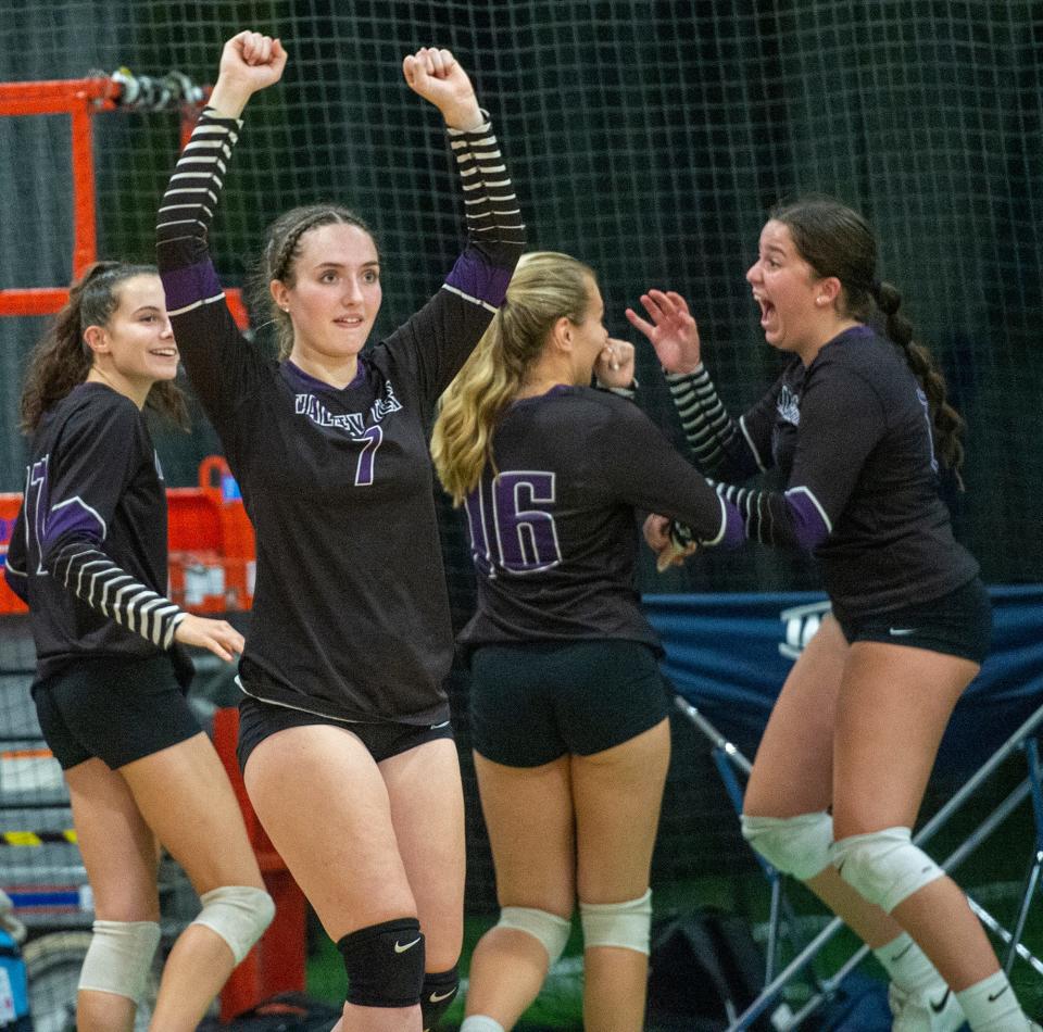 Blackstone Valley Regional Vocational Technical High School girls volleyball bench, including Abbey Derouin, #7, celebrate a point against The Advanced Math and Science Academy Charter School at Forekicks in Marlborough, Oct. 4, 2023.