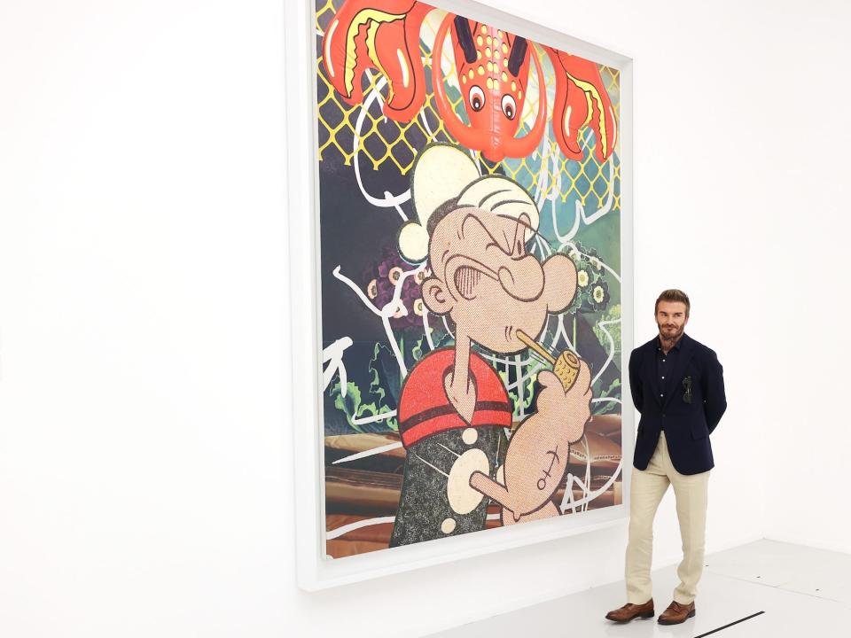 David Beckham poses with a piece by Jeff Koons.