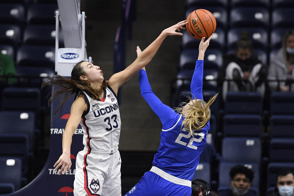 Connecticut's Caroline Ducharme (33) blocks a shot by Creighton's Carly Bachelor (22) in the second half of an NCAA college basketball game, Sunday, Jan. 9, 2022, in Storrs, Conn. (AP Photo/Jessica Hill)