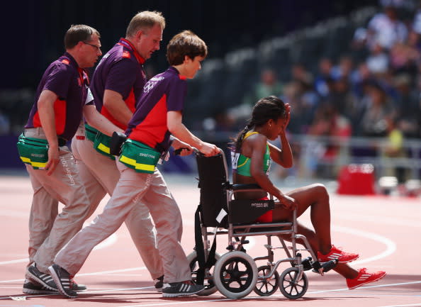 LONDON, ENGLAND - AUGUST 06: Genzebe Dibaba of Ethiopia is taken off the track in a wheelchair after she competes in the Women's 1500m heat on Day 10 of the London 2012 Olympic Games at the Olympic Stadium on August 6, 2012 in London, England. (Photo by Hannah Johnston/Getty Images)