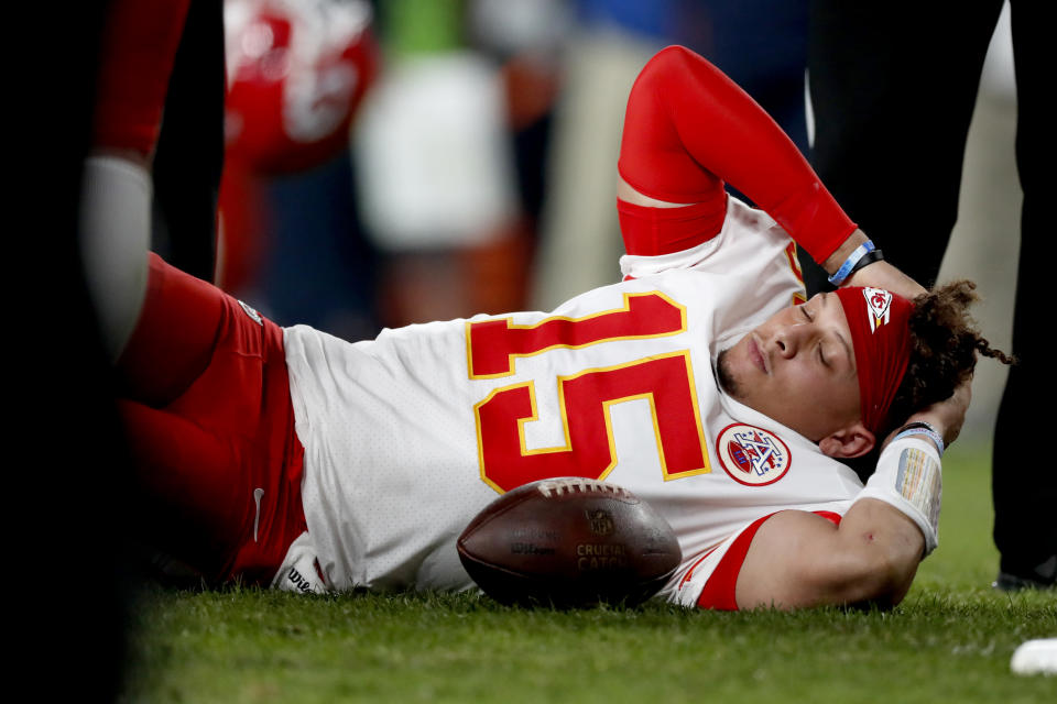 Kansas City Chiefs quarterback Patrick Mahomes (15) lies on the field after being injured against the Denver Broncos during the first half of an NFL football game, Thursday, Oct. 17, 2019, in Denver. (AP Photo/David Zalubowski)